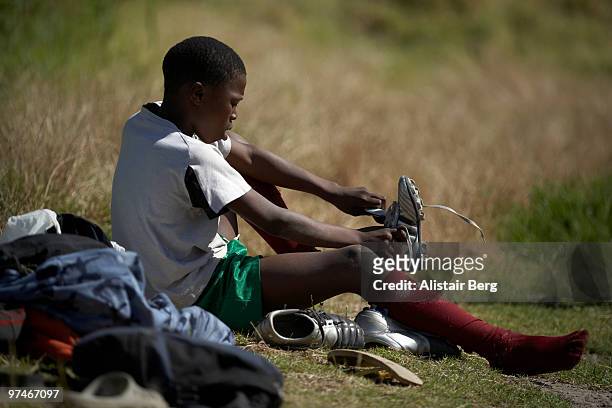 boy getting ready to play football - soccer boot stock pictures, royalty-free photos & images