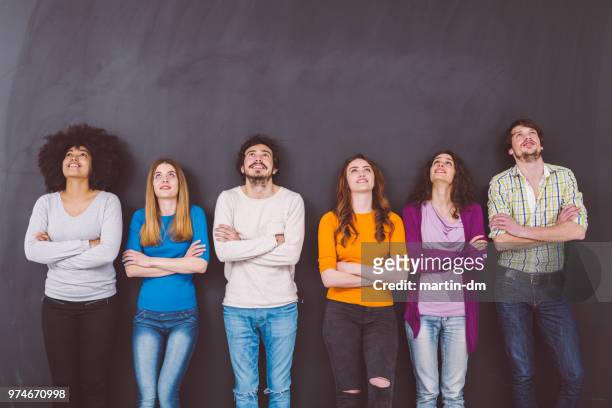 high school students against blackboard looking up - group people thinking stock pictures, royalty-free photos & images
