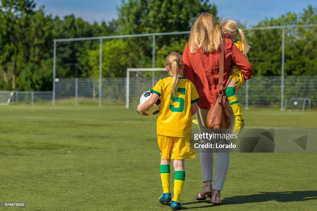 Soccer Mom accompanying her two daughters to football training