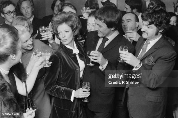 English actress Maggie Smith celebrating her Academy Award for Best Actress with her husband, English actor Robert Stephens , and friends, 8th April...