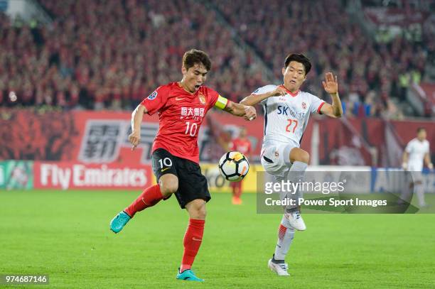 Guangzhou Midfielder Zheng Zhi fights for the ball with Jeju FC Forward Ryu Seung-Woo during the AFC Champions League 2018 Group G round 3 match...