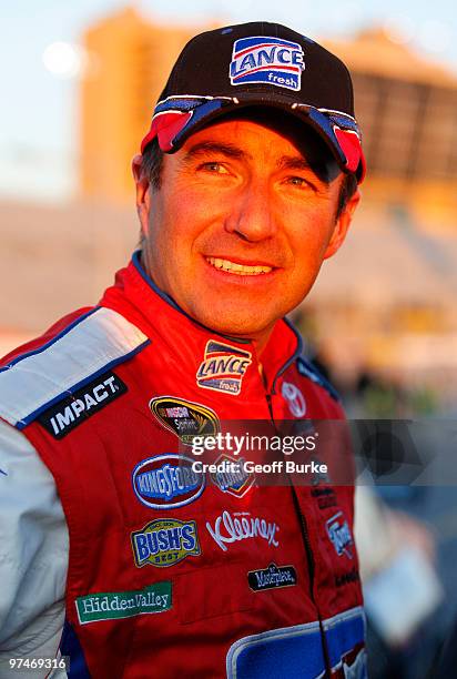 Marcos Ambrose, driver of the Lance/Tom's Toyota, stands on the grid after qualifying for the NASCAR Sprint Cup Series Kobalt Tools 500 at Atlanta...