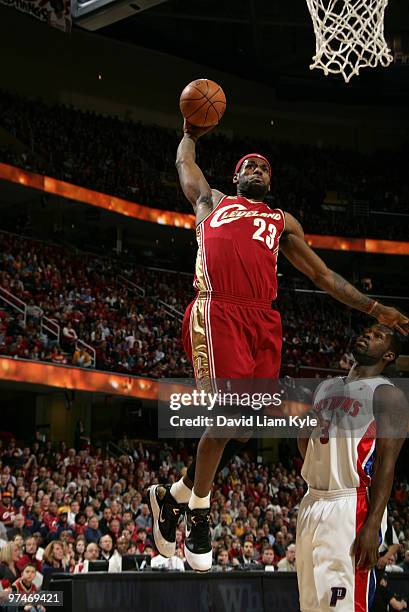 LeBron James of the Cleveland Cavaliers flies in for the dunk against Rodney Stuckey of the Detroit Pistons on March 5, 2010 at The Quicken Loans...