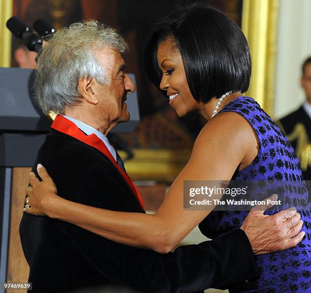 Michelle Obama congratulates Elie Wiesel at a White House ceremony presenting National Medals of the Arts and National Humanities Medals on February...