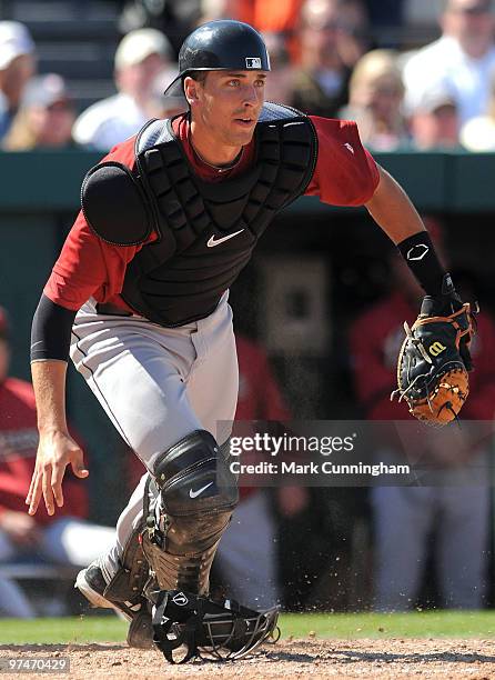 Jason Castro of the Houston Astros reacts to a wild pitch against the Detroit Tigers during a spring training game at Joker Marchant Stadium on March...