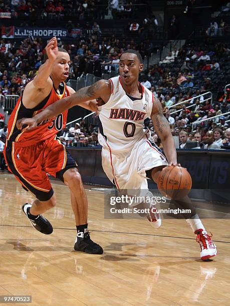 Jeff Teague of the Atlanta Hawks drives against Stephen Curry of the Golden State Warriors on March 5, 2010 at Philips Arena in Atlanta, Georgia....