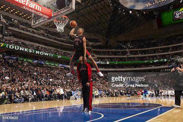 Slam Dunk Contest: Toronto Raptors DeMar DeRozan in action, leaping over teammate Sonny Weems during All-Star Saturday Night of All Star Weekend at...