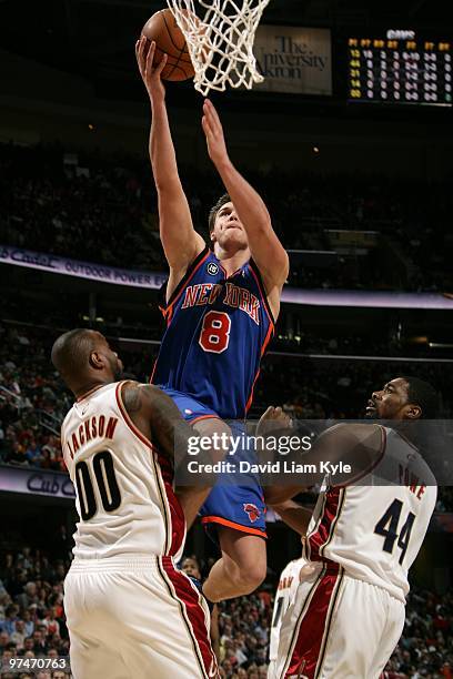 Danilo Gallinari of the New York Knicks takes the ball to the basket against Darnell Jackson and Leon Powe of the Cleveland Cavaliers during the game...