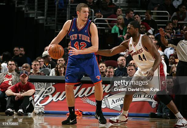 David Lee of the New York Knicks moves the ball against Leon Powe of the Cleveland Cavaliers during the game at Quicken Loans Arena on March 1, 2010...