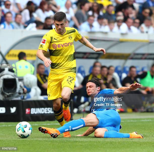 Christian Pulisic of Dortmund and Nico Schulz of Hoffenheim battle for the ball during the Bundesliga match between TSG 1899 Hoffenheim and Borussia...