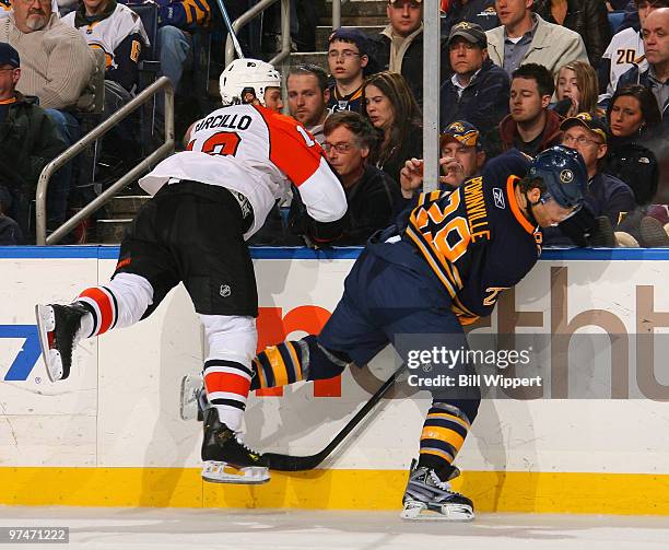 Jason Pominville of the Buffalo Sabres steps away from the check of Dan Carcillo of the Philadelphia Flyers on March 5, 2010 at HSBC Arena in...