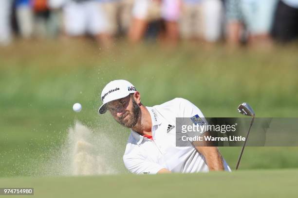 Dustin Johnson of the United States holes out for a birdie on the eighth hole during the first round of the 2018 U.S. Open at Shinnecock Hills Golf...