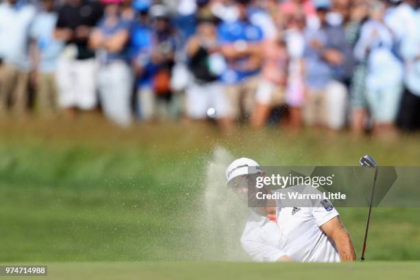 Dustin Johnson of the United States holes out for a birdie on the eighth hole during the first round of the 2018 U.S. Open at Shinnecock Hills Golf...