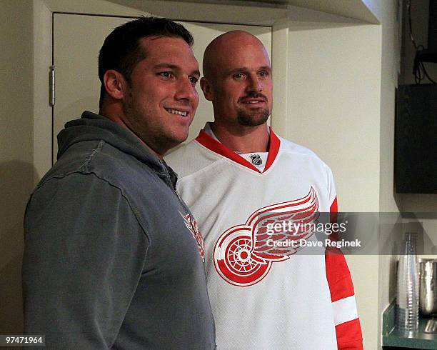 Dominic Raiola of the Detroit Lions poses with newly signed teammate Kyle Vanden Bosch during an NHL game with the Detroit Red Wings vs. The...