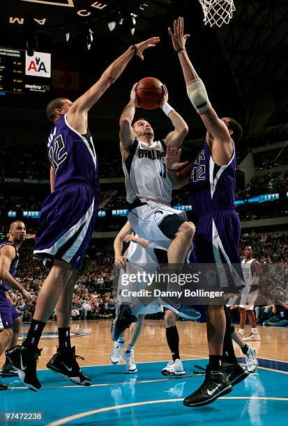 Jose Juan Barea of the Dallas Mavericks goes into the lane against Francisco Garcia and Sean May of the Sacramento Kings during a game at the...