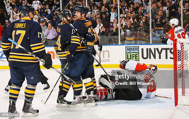 Tim Connolly of the Buffalo Sabres celebrates his game winning overtime goal against Michael Leighton of the Philadelphia Flyers with teammates...