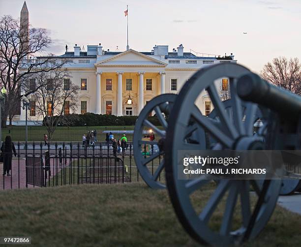 The White House is seen past the decorative canons in Lafayette Park around sunset March 5 in Washington, DC. The park in front of 1600 Pennsylvania...