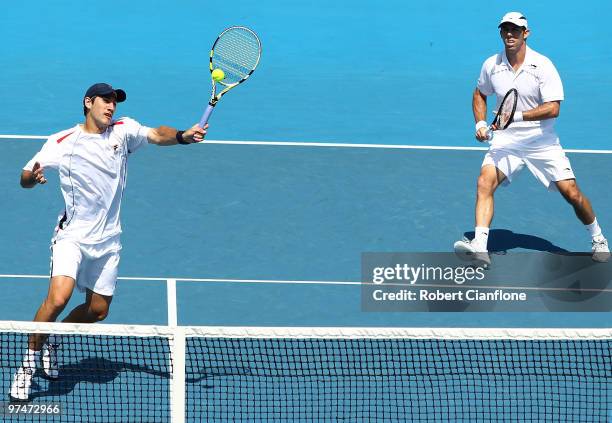 Carsten Ball of Australia returns a shot as Paul Hanley looks on during their doubles match against Tsung-Hua Yang and Chu-Huan Yi of Chinese Taipei...