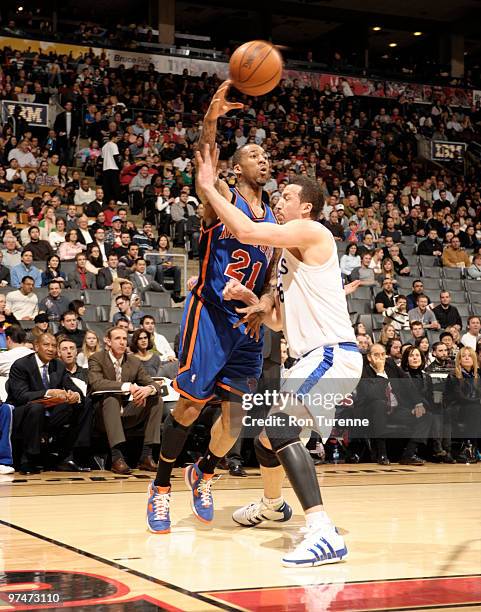 Wilson Chandler of the New York Knicks makes the baseline pass around Hedo Turkoglu of the Toronto Raptors during a game on March 05, 2010 at the Air...