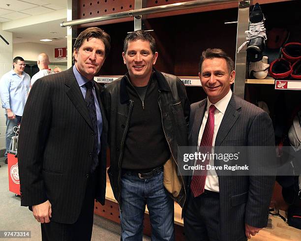 After the Detroit Red Wings 5-2 win against the Nashville Predators, Coach Mike Babcock poses with Detroit Lions Coach Jim Schwartz and Ken Holland...