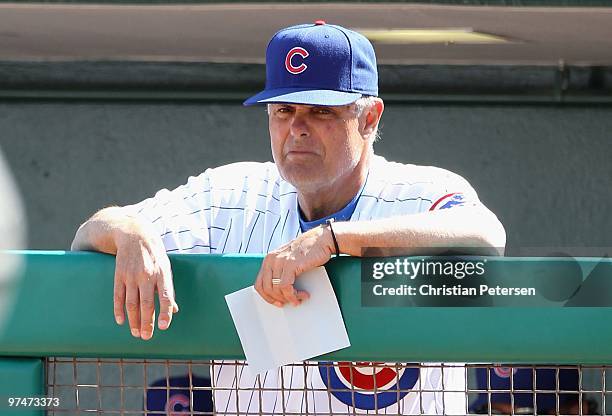 Manager Lou Piniella of the Chicago Cubs watches from the dugout during the MLB spring training game against the Oakland Athletics at HoHoKam Park on...