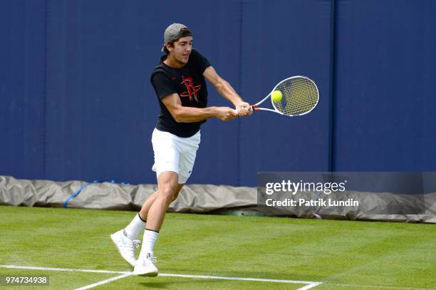 Thanasi Kokkinakis of Australia hits a backhand in practice during preview Day 2 of the Fever-Tree Championships at Queens Club on June 14, 2018 in...