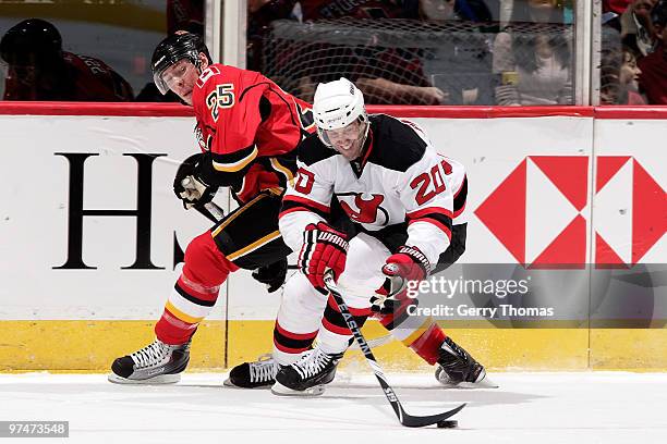 Jay Pandolfo of the New Jersey Devils skates with the puck against David Moss of the Calgary Flames March 5, 2010 at Pengrowth Saddledome in Calgary,...