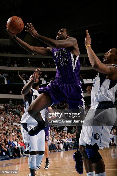 Donte Greene of the Sacramento Kings goes up for a shot against Caron Butler of the Dallas Mavericks during a game at the American Airlines Center on...