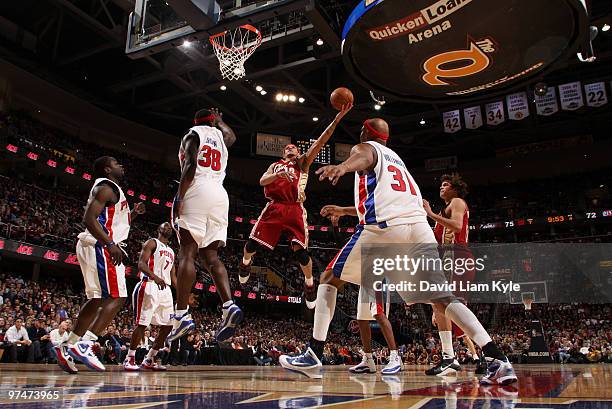 Delonte West of the Cleveland Cavaliers goes up for the shot against Kwame Brown and Charlie Villanueva of the Detroit Pistons on March 5, 2010 at...