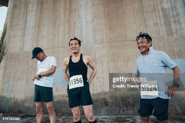 three senior men preparing to run a marathon - 3 old men jogging stock-fotos und bilder