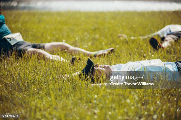 three senior adults exhausted after running a marathon - 3 old men jogging stock-fotos und bilder