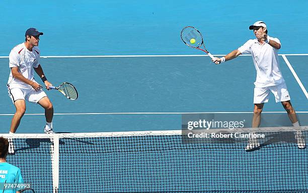 Paul Hanley of Australia returns a shot as Carsten Ball looks on during their doubles match against Tsung-Hua Yang and Chu-Huan Yi of Chinese Taipei...