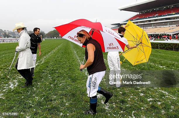 Jockey's Dwayne Dunn; Claire Lindrop and Craig Williams discuss the condition of the track with Stipendiary Steward Sally Miller after a hail storm...