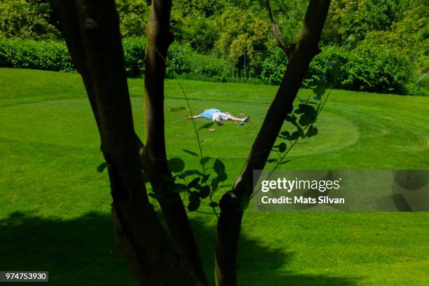 desperate golfer lying on the tee box with broken golf club driver - broken golf club stock pictures, royalty-free photos & images