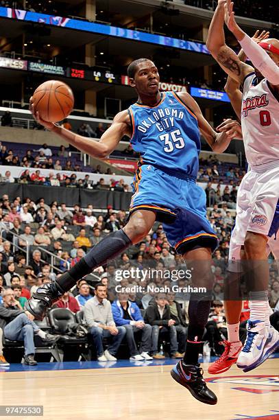 Kevin Durant of the Oklahoma City Thunder leaves his feet to make a pass against Drew Gooden of the Los Angeles Clippers at Staples Center on March...