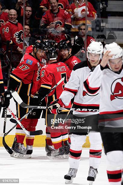 Rene Bourque, Ian White and Jarome Iginla of the Calgary Flames celebrate a goal against the New Jersey Devils on March 5, 2010 at Pengrowth...