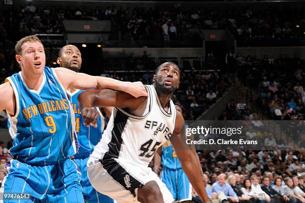 DeJuan Blair of the San Antonio Spurs defends the basket against Darius Songaila of the New Orleans Hornets on March 5, 2010 at the AT&T Center in...