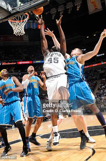 DeJuan Blair of the San Antonio Spurs shoots against Darius Songaila of the New Orleans Hornets on March 5, 2010 at the AT&T Center in San Antonio,...