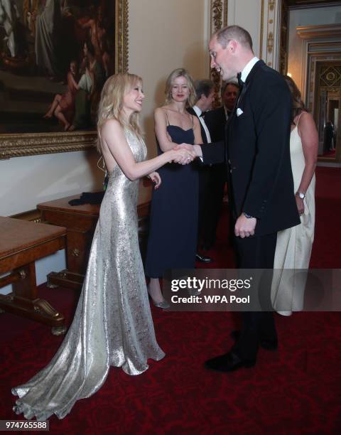 Kylie Minogue speaks with Prince William, Duke of Cambridge during a reception for the Royal Marsden NHS Foundation Trust at Buckingham Palace on...