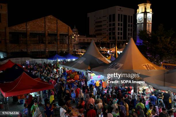 Malaysian Muslims are seen in a bazaar in Sungai Petani for a last minute shopping during the Eid al-Fitr night eve. On June 15 Muslim throughout the...