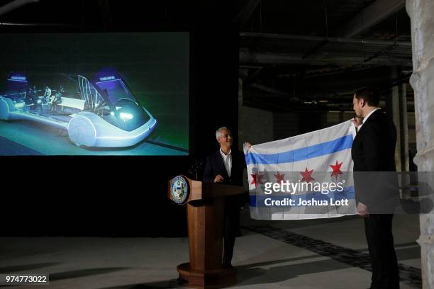Chicago Mayor Rahm Emanuel presents a Chicago flag to engineer and tech entrepreneur Elon Musk of The Boring Company during a news conference at...