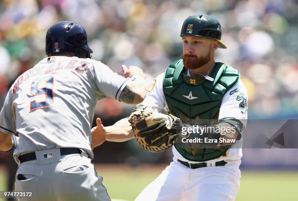 Jonathan Lucroy of the Oakland Athletics tags out Marwin Gonzalez of the Houston Astros in a rundown in the second inning at Oakland Alameda Coliseum...