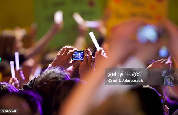 Fans cheer and take pictures while Milow perform live at ''The Dome 53'' concert event at the Velodrom on March 5, 2010 in Berlin, Germany.