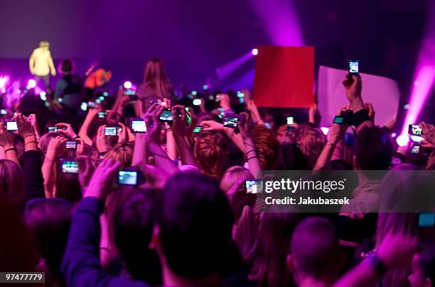 Fans cheer and take pictures while Justin Bieber performs live at ''The Dome 53'' concert event at the Velodrom on March 5, 2010 in Berlin, Germany.