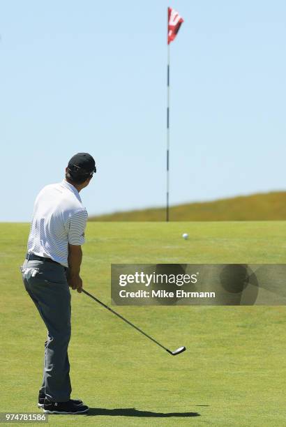 Kevin Kisner of the United States chips to the tenth hole during the first round of the 2018 U.S. Open at Shinnecock Hills Golf Club on June 14, 2018...