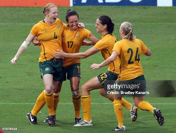 Kyah Simon of Australia celebrates with team mates after scoring a match winning goal in the final minutes of the match during the international...