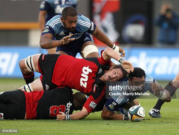 Jerome Kaino of the Blues dives on a loose ball with Richie McCaw captain of the Crusaders and team mate Viliami Ma'afu in support during the round...