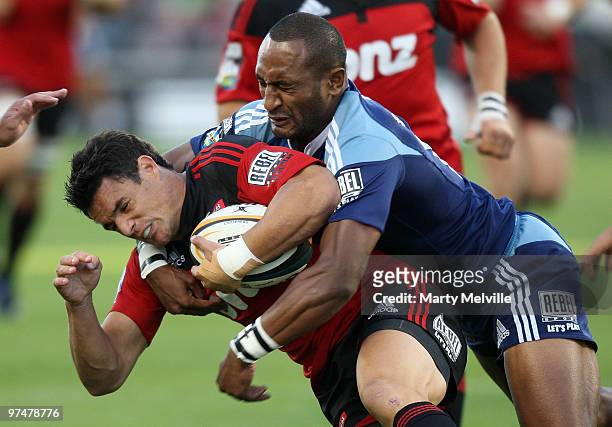 Dan Carter of the Crusaders is tackled by Joe Rokocoko of the Blues during the round four Super 14 match between the Crusaders and the Blues at AMI...