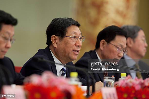 Zhang Ping, director of China's National Development and Reform Commission , second from left, speaks at a news conference at the Great Hall of the...