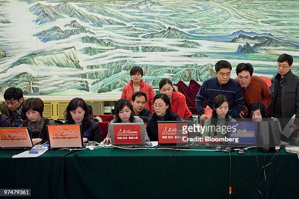 Members of China's state run media work at a news conference at the Great Hall of the People in Beijing, China, on Saturday, March 6, 2010. Zhou...